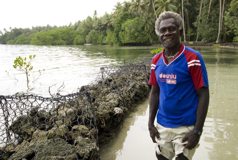 The Carterets are six small sand islands that surround an atoll about 86 km north-east of Bougainville, Papua New Guinea. The Islands have a maximum elevation of 1.5 meters above sea level and are rapidly being engulfed by rising seas. The communities occupying them are losing access to fresh water, with consequent health effects, and the advancing saltwater is destroying crops.