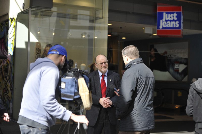 Andrew Hewett, Oxfam Australia Executive Director, talk to the media outside Just Jeans store in Bourke Street, Melbourne. Photo: Lara McKinley/OxfamAUS