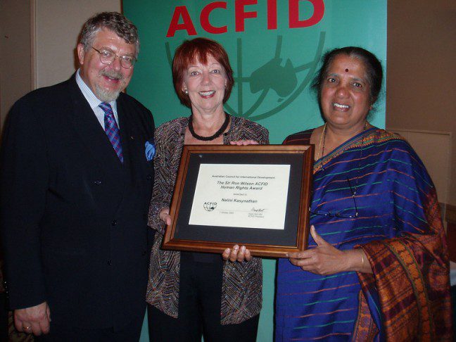 Nalini Kasynathan, Sri Lanka/Bangladesh Program Coordinator, Oxfam Australia, recieves the Ron Wilson Human Rights Award from ACFID's Gaye Hart. Also pictured: Dr Sev Ozdowski OAM