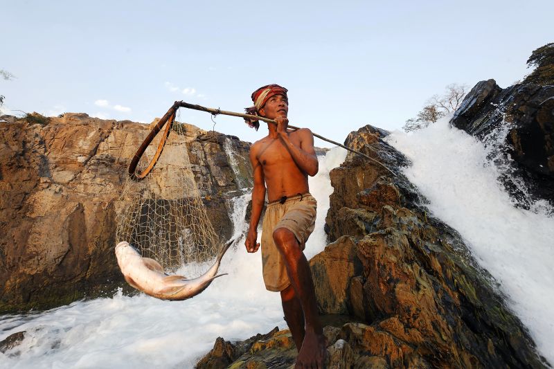 Samnieng Kampai harvest fish from powerful Khong fall in Southern Laos.