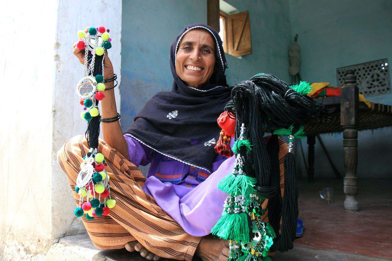 Asia, holding parandas (hair decorations) that she makes and sells. Photo: Jane Beesley/Oxfam Asia, holding parandas (hair decorations) that she makes and sells. Photo: Jane Beesley/Oxfam