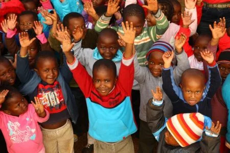 Pupils from Nokuthula's creche wave to the camera. Photo: Matthew Willman/OxfamAUS Pupils from Nokuthula's creche wave to the camera. Photo: Matthew Willman/OxfamAUS
