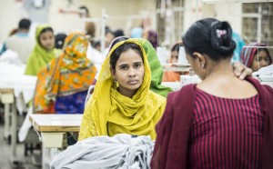 The garment industry in Bangladesh is vital to its economy. Its labour force is made up largely of women (estimates are between 80 - 90%) who earn on average just $0.16 per hour. This image shows a woman working in a garment factory in Dhaka, Bangladesh. Photo: Nicola Bailey/ActionAid