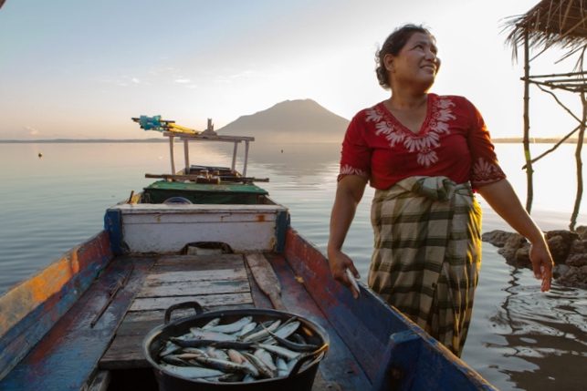 Soon after sunrise, Umikalsum, 41, brings his son's catch from the boat to the family home. She lives in Kubur Cina, a neighbordhood of Lewoleba, Nubatukan subdistrict, Lembata district, East Nusa Tenggara province, Indonesia.