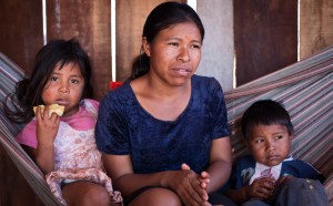 Edilza Duarte, 24, with daughter Stephanie Duarte and son Jason Duarte. Guarani Kaiowa people at Jatayvary Indigenous Land
Ponta Pora, Mato Grosso do Sul State. Brazil. She says that the sugar plantations have put an end to her culture by clearing the forest and spreading 'poison' (the chemicals sprayed on the sugar plantations). Photo: Tatiana Cardeal/Oxfam