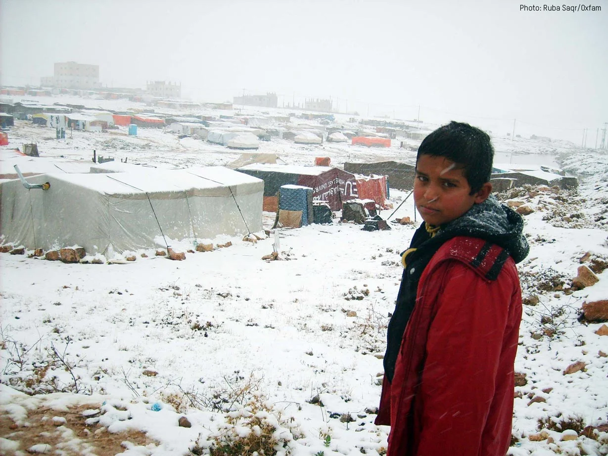 10 year old Kasser overlooking the informal tented settlement his Syrian family is currently living in. Photo: Ruba Saqr/Oxfam