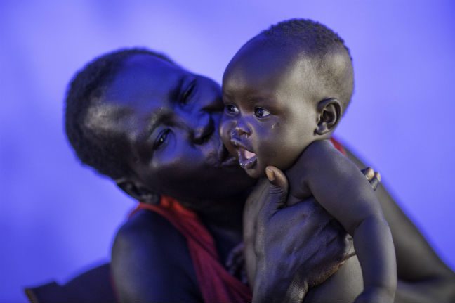 Elizabeth and baby Swampy. Photo: Kieran Doherty/Oxfam