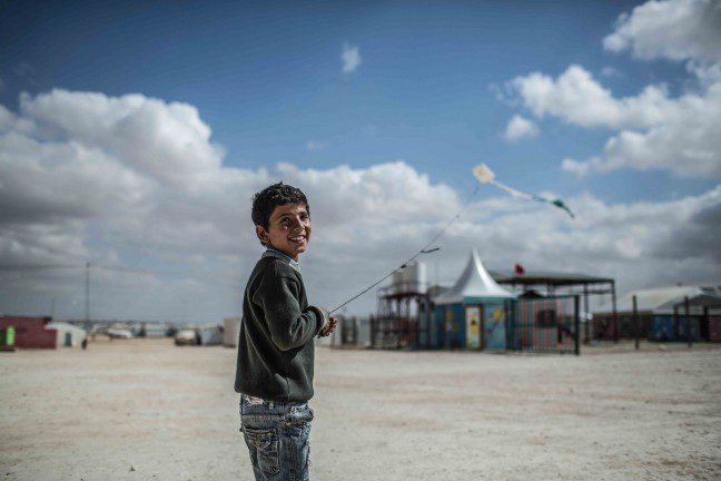 Omar*, 13, from Daraa in Syria, flies a kite in Zaatari refugee camp in Jordan. “Every time I fly my kite, I feel free,” he says. Photo: Pablo Tosco/Oxfam