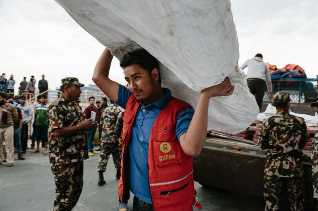 Oxfam volunteer Shekhou Khadka (23) works to off load latrines being delivered to the Tundikhel IDP camp in Kathmandu, Nepal. He is one of 500 volunteers trained to react in the event of an earthquake during the urban risk management program. “I’m sleeping under canvass outside our house but my family are safe. I became a volunteer because I wanted to serve my community. The big challenges that lie ahead: supplying food, water, health care, and the scarcity of food.” Photo: Aubrey Wade. Nepal earthquake donations Photo: Aubrey Wade