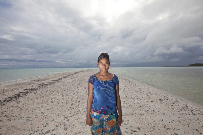 Photo: Rodney Dekker/OxfamAUS A woman stands on a deserted beach