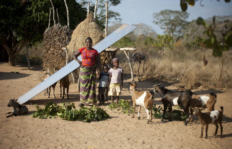 Photo: Abbie Trayler-Smith/Oxfam AUS Goats from Oxfam Unwrapped helped build the new house that Delfinia stands in front of with her two children