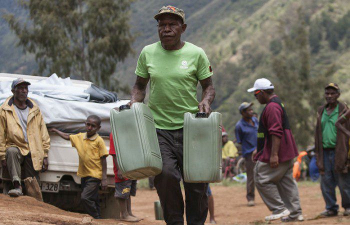 Staff from Oxfam and partner organisations distributing emergency kits in Womkama, PNG.