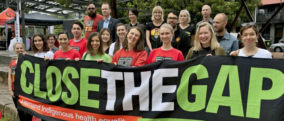 National Close the Gap participants hold a banner in support of Indigenous health equality