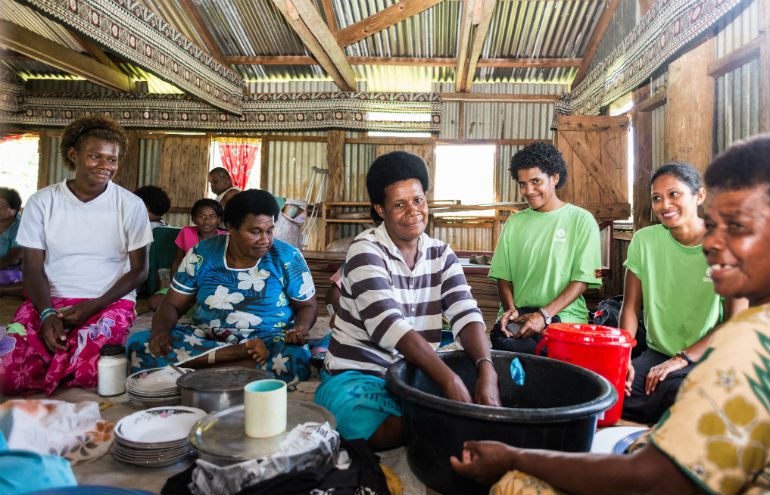 Photo: Alfredo Prado/OxfamAUS Mere Liku (centre) with other women of the village of Nasiriti in Fiji are washing the dishes affter a community gathering. Oxfam is supporting them with soap, buckets and other sanitation tools to prevent the spread of diseases.
