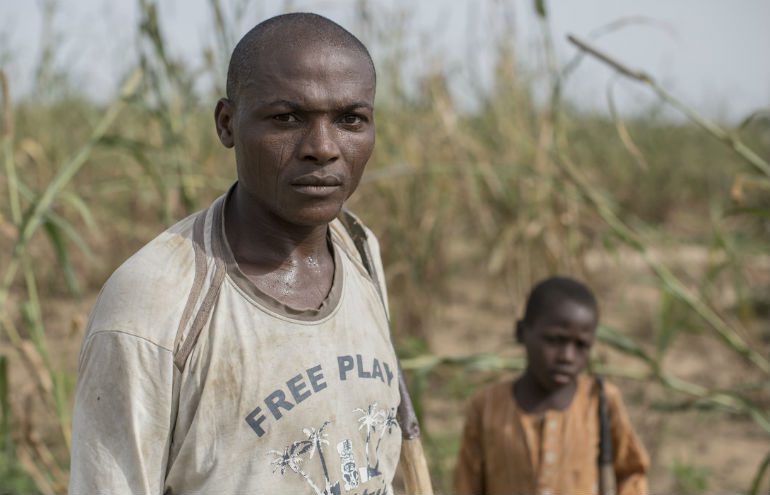 Hassan*, 35, a father of six, with his sons, in the field he rents on the outskirts of Maiduguri, Nigeria.
Photo: Sam Tarling / Oxfam Photo: Sam Tarling / Oxfam
