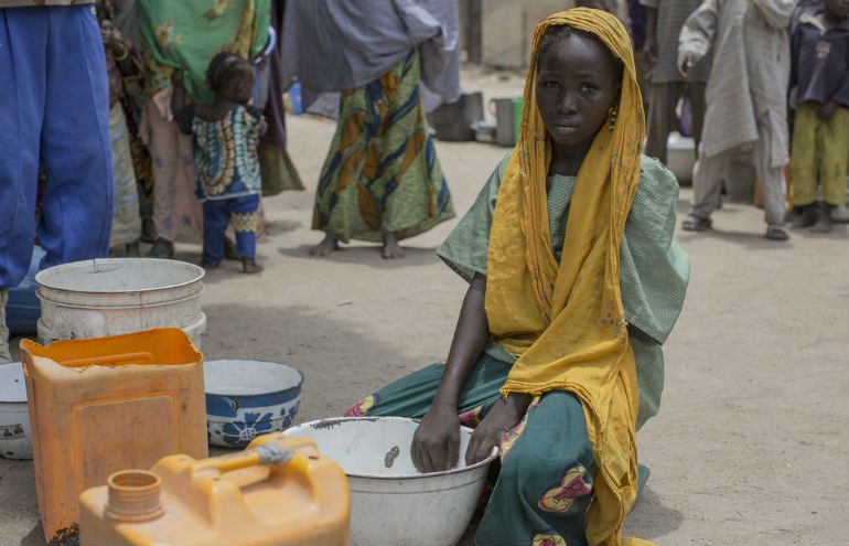 Hwaida*, 10, queues to collect water in the camp at Banki. She said that she had been waiting all morning and usually spent at least two hours a day waiting for water.
Photo: Sam Tarling / Oxfam Photo: Sam Tarling / Oxfam