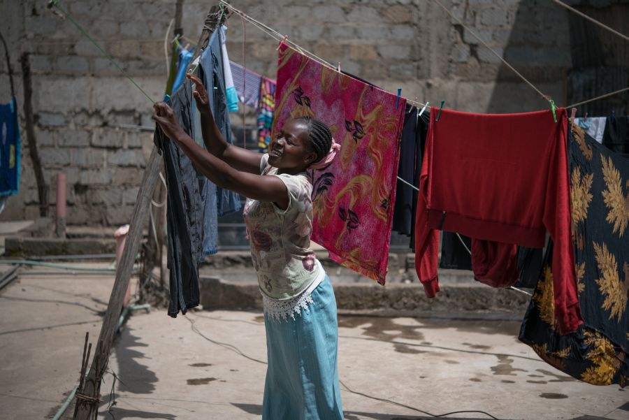 Tabitha Mwikali, 36, a domestic worker hanging clothes for her employer in Eastleigh, Nairobi, Kenya. 2016. Photo: Allan Gichigi/Oxfam