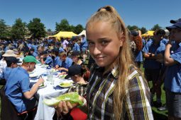 girl standing in sun holding food