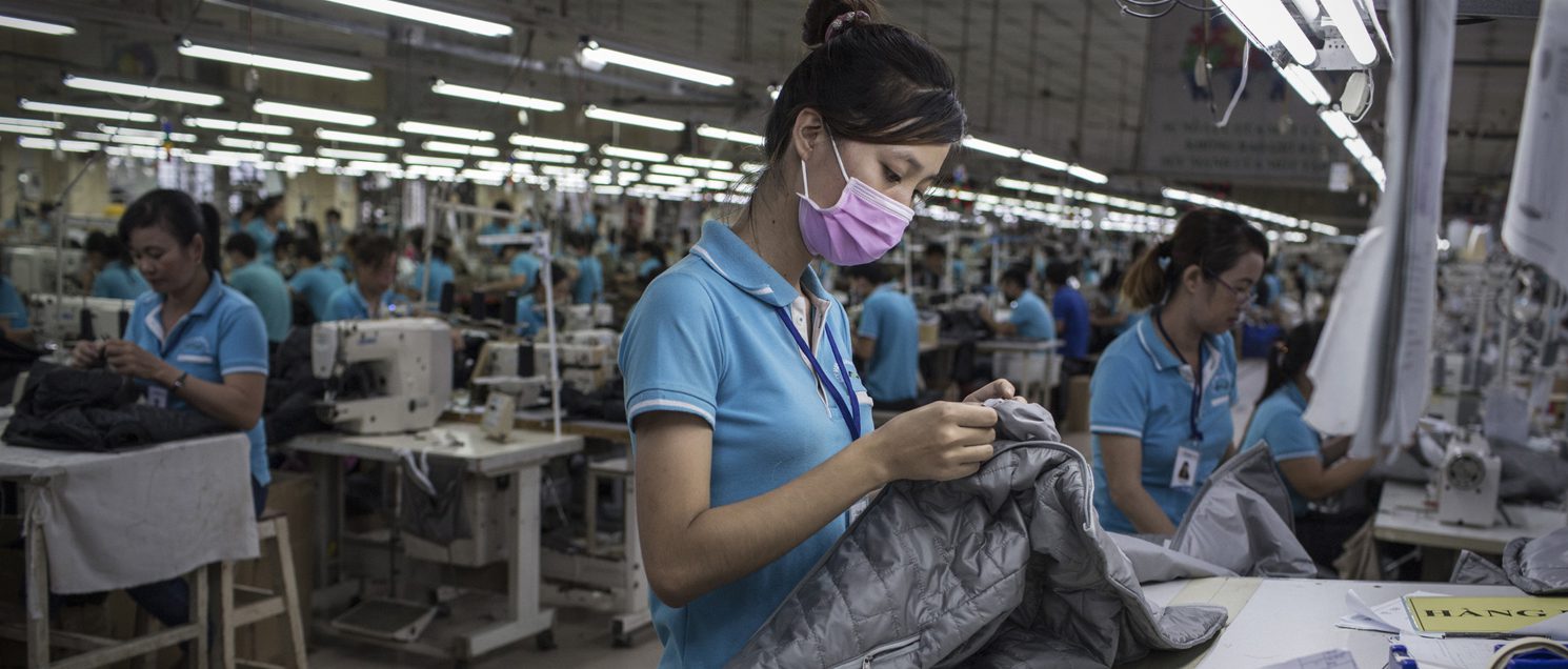 A woman works on a clothing line for an international brand in Dong Nai province, Vietnam. Photo: Sam Tarling/Oxfam