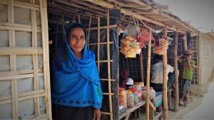 Rajiah outside her home in the refugee camp on her way to visit her pregnant neighbor in Cox's Bazar, Bangladesh.