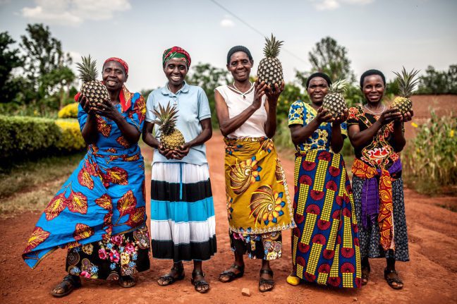 Kirehe district, Rwanda: Tuzamurane cooperative members (from left to right) Theresie, Valerie, Christine, Josepha and Mukeshimana stand outside the co-op centre in Eastern Rwanda. Photo: Aurelie Marrier d’Unienville/Oxfam. Kirehe district, Rwanda: Tuzamurane cooperative members (from left to right) Theresie, Valerie, Christine, Josepha and Mukeshimana stand outside the co-op centre in Eastern Rwanda. Photo: Aurelie Marrier d’Unienville/Oxfam.