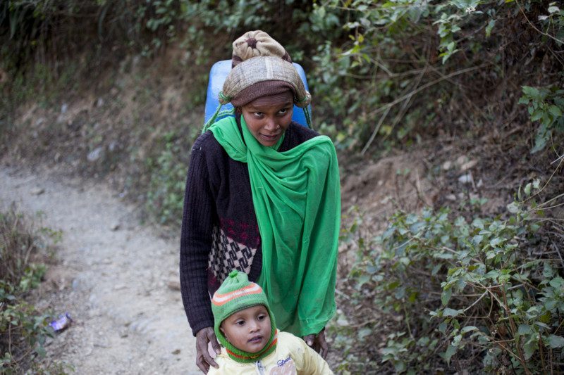 She carries heavy loads of water, despite being pregnant