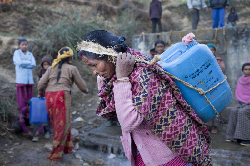 Baitadi, Nepal: Hira Bohara (42),collects water in Baitadi. 