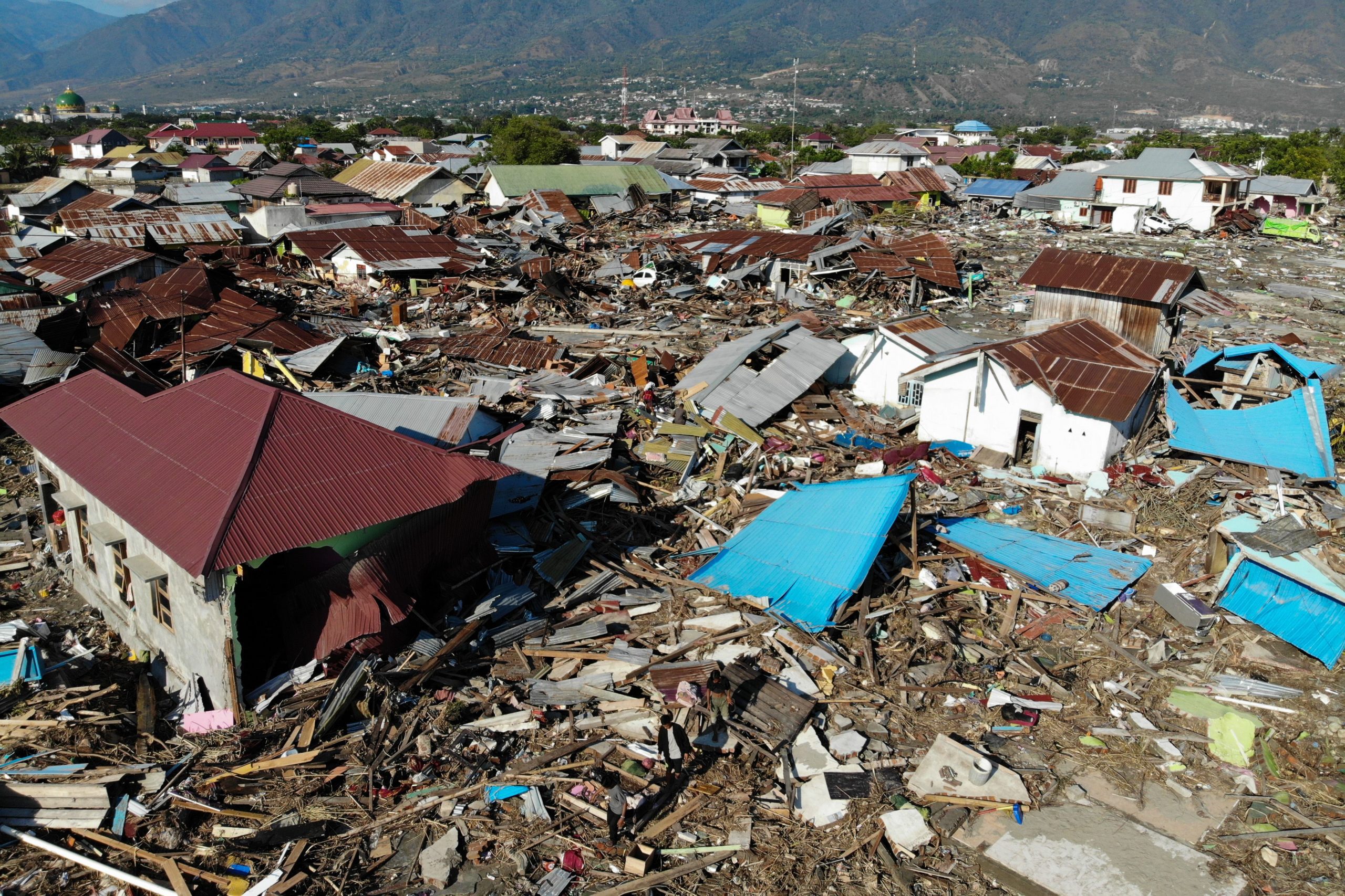 <p>
An aerial view shows the earthquake and tsunami devasted neighbourhood in Palu, Indonesia's Central Sulawesi on October 1, 2018. - The death toll from the Indonesian quake-tsunami nearly doubled to 832 but was expected to rise further after a disaster that has left the island of Sulawesi reeling. (Photo by JEWEL SAMAD / AFP) (Photo credit should read JEWEL SAMAD/AFP/Getty Images)</p>