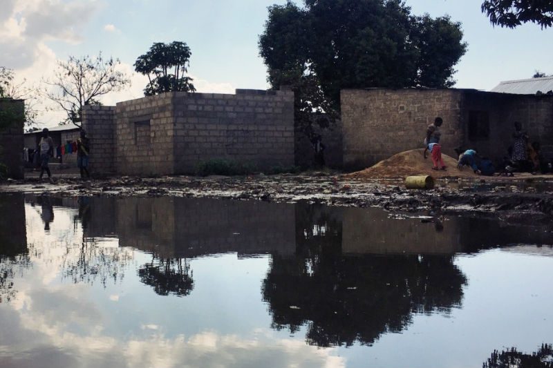 Photo above: In the dry season, this peri-urban settlement has stagnant water everywhere. People hop from stone to stone to avoid it. Others have no choice but to use water like this to wash their clothes and dishes because they can’t afford to miss work and line up for several hours at a tank. Photo above: In the dry season, this peri-urban settlement has stagnant water everywhere. People hop from stone to stone to avoid it. Others have no choice but to use water like this to wash their clothes and dishes because they can’t afford to miss work and line up for several hours at a tank.