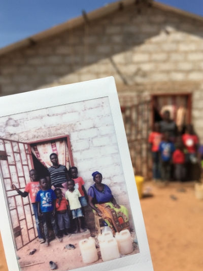 Photo above: Priscilla standing in the doorway of her home with her mother and biological and adopted children. I take instant family portraits for the people I interview. It is often the first printed photo they have of their family, so it is welcomed with excited faces. Photo above: Priscilla standing in the doorway of her home with her mother and biological and adopted children. I take instant family portraits for the people I interview. It is often the first printed photo they have of their family, so it is welcomed with excited faces.