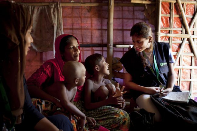 Rohingya refugee Asia Bibi* with solar powered lamp provided by Oxfam, in her shelter in the camps in Cox’s Bazar, Bangladesh.