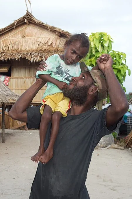 Jose with his child. Jose is a Safe Families participant & community member, in Malaita Province. Photo credit: Alice Plate/OxfamAUS.