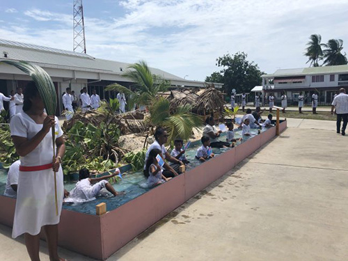Children greet world leaders while sitting in water in front of a ravaged island. Photo: Simon Bradshaw/Oxfam Australia Children greet world leaders while sitting in water in front of a ravaged island. Photo: Simon Bradshaw/Oxfam Australia