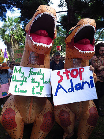 Dinosaurs at the #ClimateStrike Photo: Jenny Templin Dinosaurs at the #ClimateStrike with a sign that reads "My Family thought they had time too"