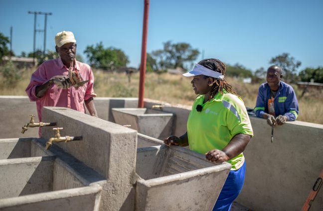 Takudzwa, 33yrs, an Oxfam WASH Engineer is photographed working at a laundry station near an Oxfam funded solar piped water system in Somerton village, Masvingo District, Zimbabwe. The system will supply water to a local school and clinic as well as many families in the local community.