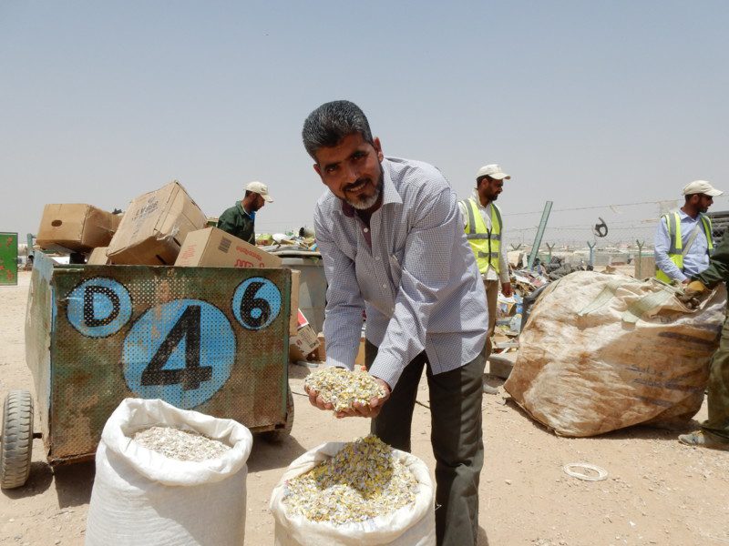 Photo: James Riturban/OxfamAUS Man smiling while showing his grain