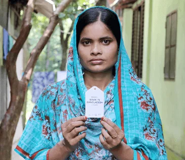 Garment worker holding price tag in her hands