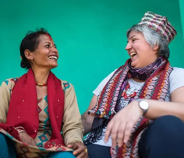 Jacqui sits with Sushila in Nepal