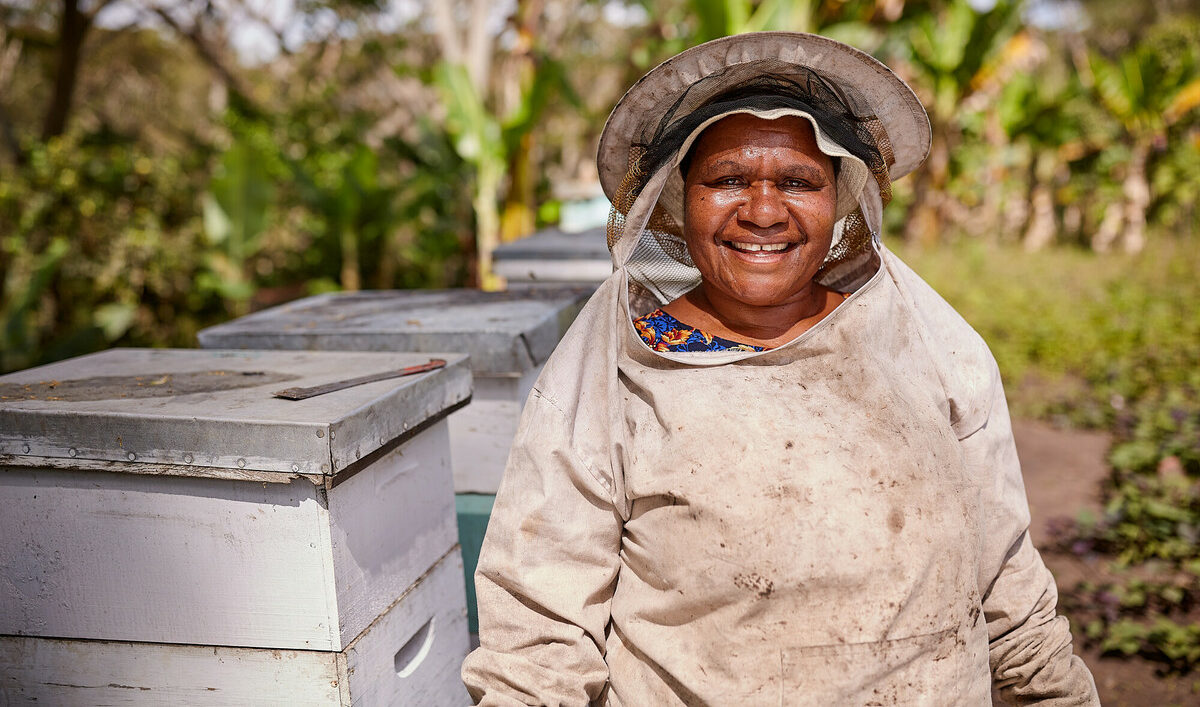 Eastern Highlands, Papua New Guinea: Onano Kapila prepares to collect honey from her hives in the Eastern Highlands. Photo: Patrick Moran/OxfamAUS Eastern Highlands, Papua New Guinea: Onano Kapila prepares to collect honey from her hives in the Eastern Highlands. Photo: Patrick Moran/OxfamAUS