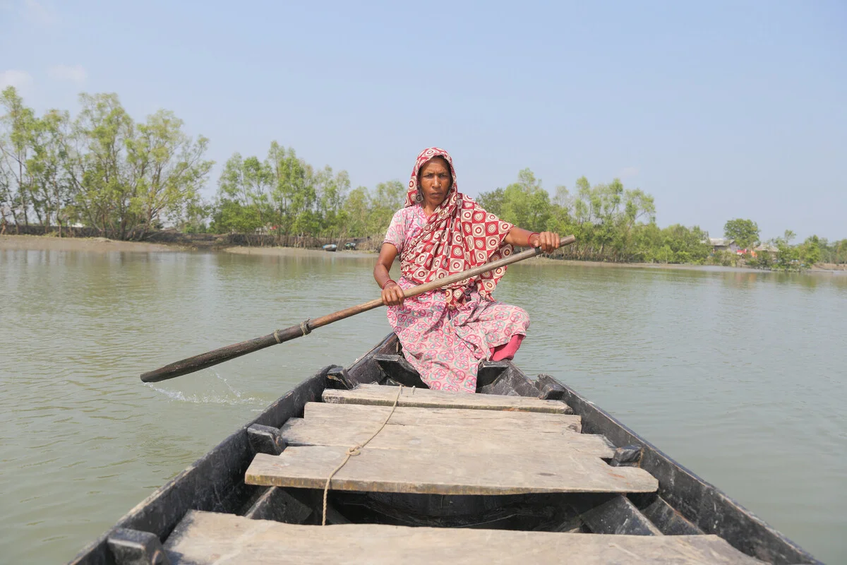 Firoza helped women and children of Golakhali to cross the river while taking shelter during cyclone Bulbul. Ramzannagar, Sathkhira. A woman rows a boat over a swelling river