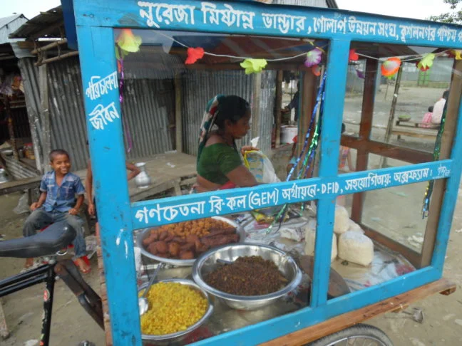 “I received the training and felt confident enough to start a small business.” Nooreja Begum tends her ‘mobile sweet shop’.