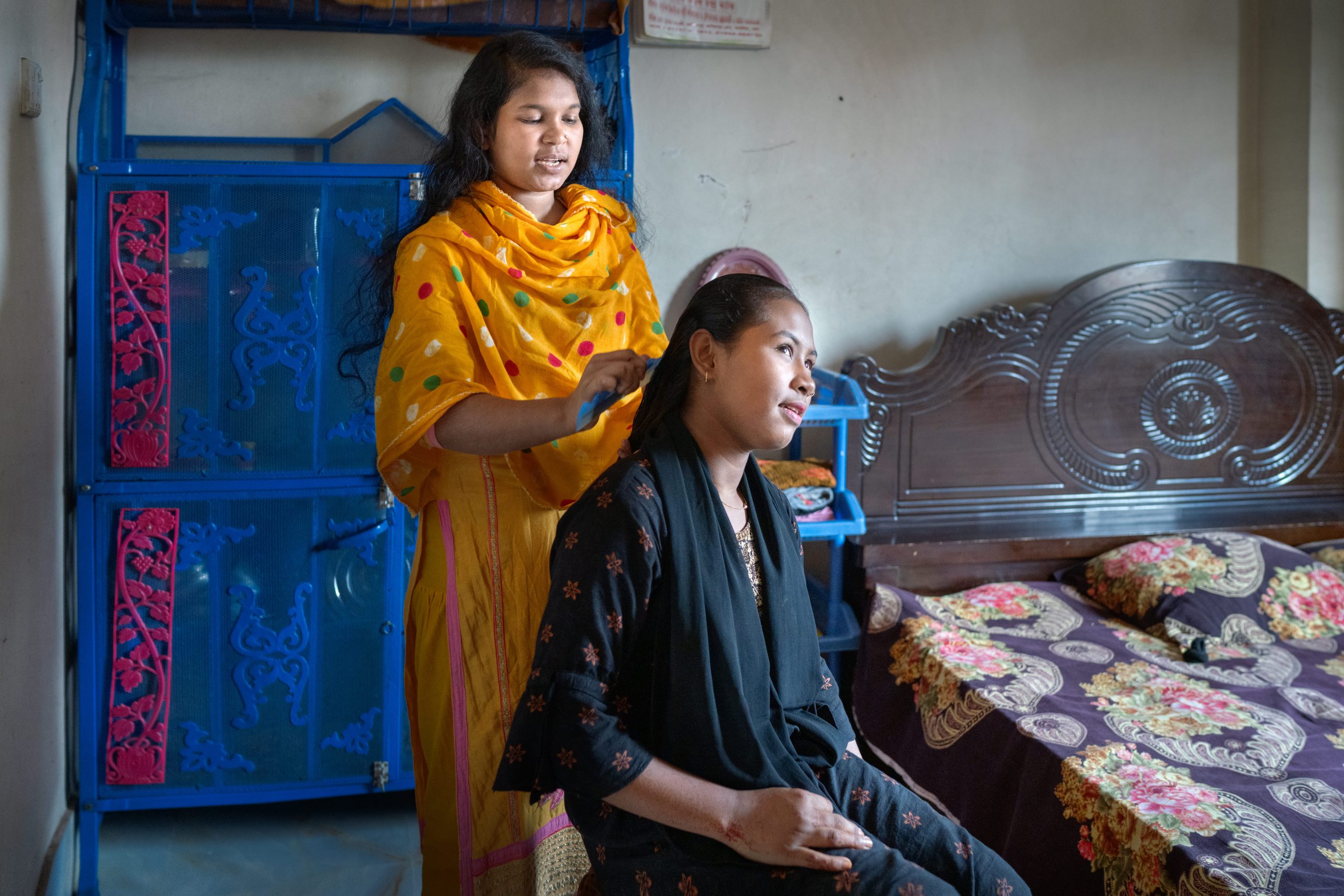 Rumi brushes her niece's hair