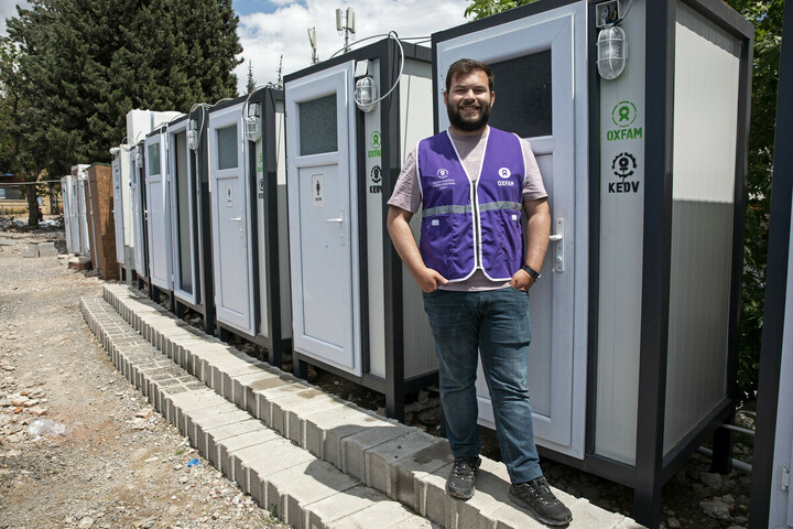 Turkiye: Sevde is standing next to the sanitary station. There is a shower inside which people staying in the camp can make use off. Photo: Delizia Flaccavento/Oxfam