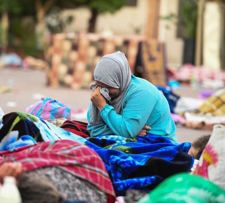 A woman reacts as people sleep on a street following the powerful earthquake in Marrakesh, Morocco on September 10, 2023. Photo: Piero Cruciatti/Anadolu Agency via Getty Images Aftermath of powerful quake in Morocco. Photo: Piero Cruciatti/Anadolu Agency via Getty Images