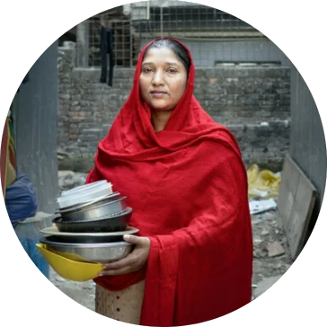 37 years old Shaila* is doing her daily chores inside her house. At 11 Shaila* joined a garment factory as a helper but now she is a home-based garment worker. She left the factory job 15 years ago and since then started taking orders from Garments and works from home. Her job includes cutting yarn, and attaching buttons, on average, she cuts 500 yarns in a day. Mirpur, Dhaka, Bangladesh. Photo: Fabeha Monir/Oxfam
37 years old Shaila* is doing her daily chores inside her house. At 11 Shaila* joined a garment factory as a helper but now she is a home-based garment worker. She left the factory job 15 years ago and since then started taking orders from Garments and works from home. Her job includes cutting yarn, and attaching buttons, on average, she cuts 500 yarns in a day. Mirpur, Dhaka, Bangladesh. Photo: Fabeha Monir/Oxfam