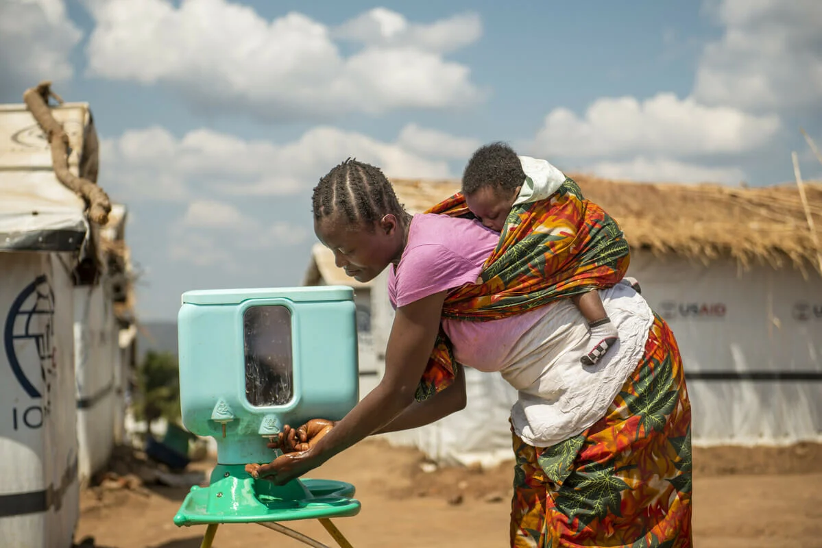 Hernestine using Oxfam handwashing stand to wash her hands. Democratic Republic of Congo. Credit: Arlette Bashizi/Oxfam
