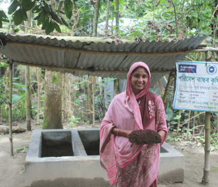 Kurigram, Bangladesh: Shabana stands in front of her compost plant, proudly displaying the fertiliser she produced. Photo: Munir Hossain/Oxfam