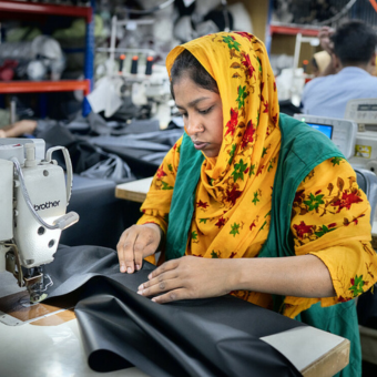 Bangladesh: Textile workers are working inside a garment factory in Savar. Photo: Fabeha Monir/Oxfam A textile worker using a sewing machine inside a factory in Bangladesh.