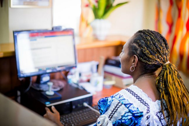 Jacquline looks at her computer. Jacquline is a graduate of Youth Challenge Vanuatu's (YCV) Ready for Work program, and now works at the ombudsman office in Vanuatu. YCV work with the community help challenge inequality and provide opportunities. Photo: Arlene Bax/Oxfam