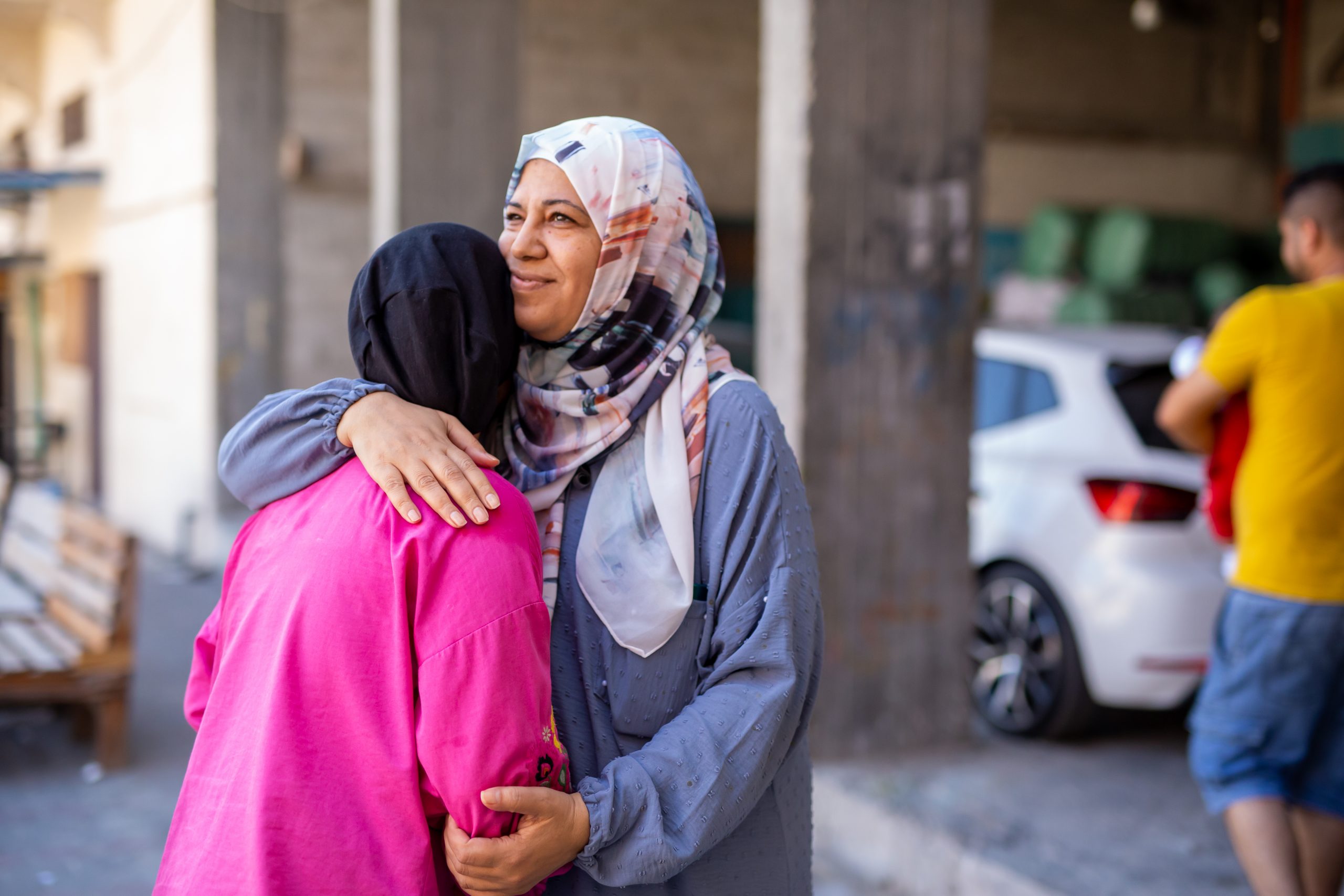 Palestinian Territory: Huwaida, who manages a shelter in the Gaza Strip, hugs her daughter. Photo: Marwan Sawwaf/Alef MultiMedia/Oxfam.